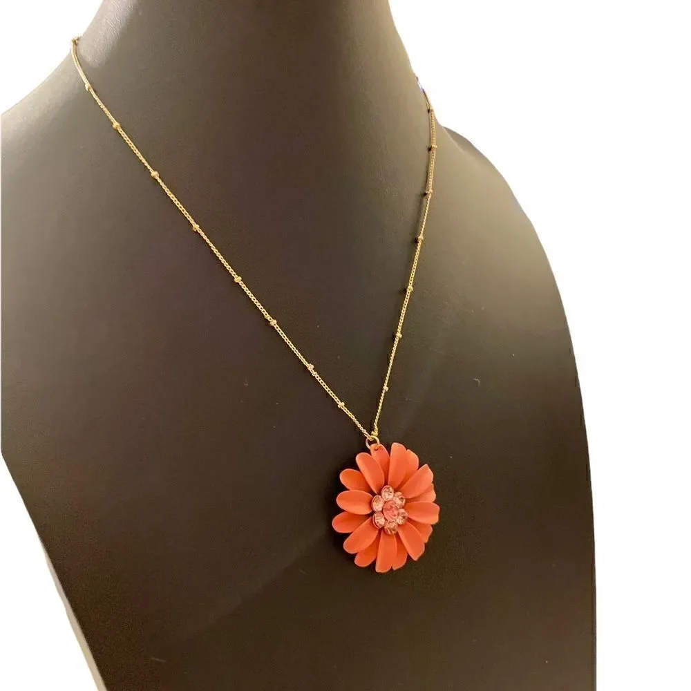 Beautiful Orange Flower Necklace on a delicate looking gold toned chain.